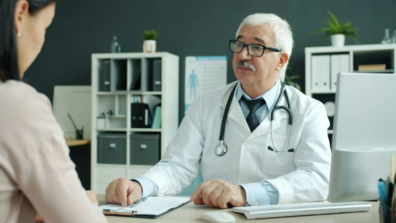 Endocrinologist explaining a diabetes care plan to a patient during a consultation