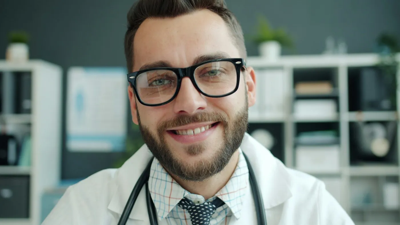 Smiling physician in a white coat with a stethoscope